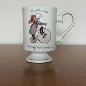Holly Hobbie Porcelain Pedestal Coffee Mug -Frienship Makes The Rough Road Smooh